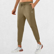 Model showcasing GPW men's lightweight trousers with brown zipper pocket for athletic workouts, running, and casual wear