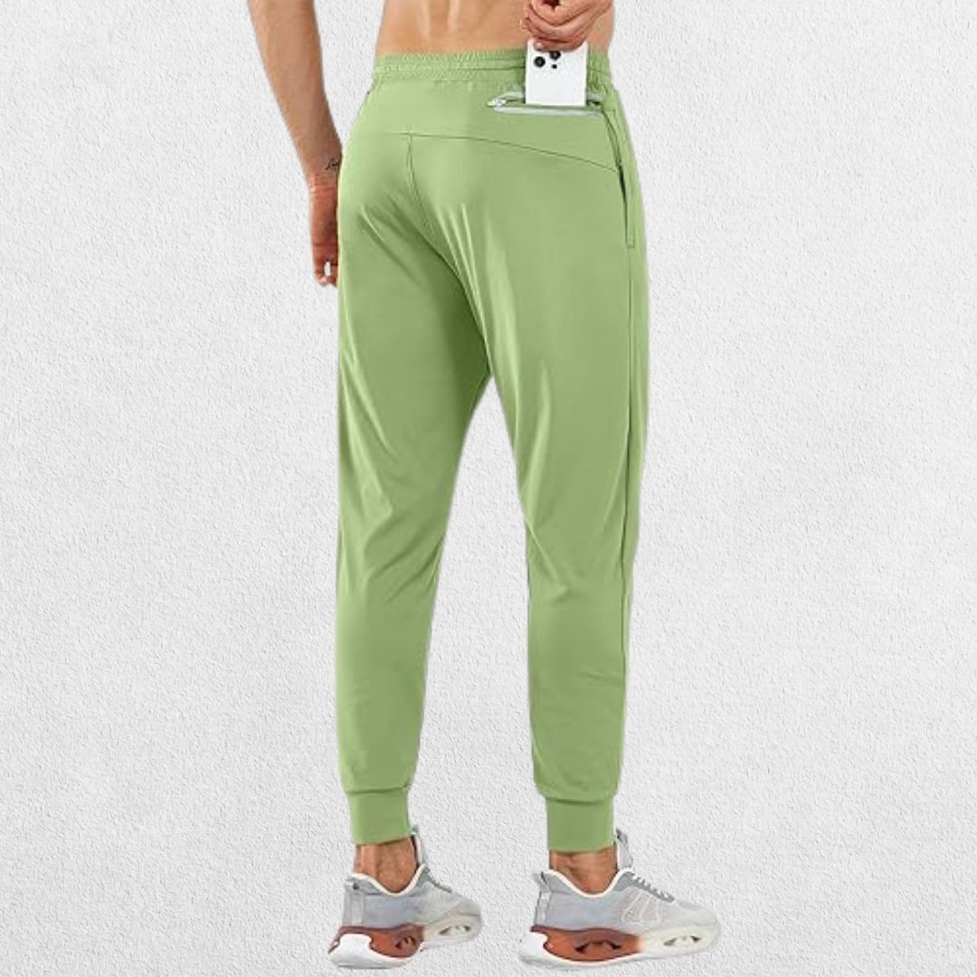 Model placing phone in back zipper pocket of GPW Men's Lightweight Trousers, showcasing secure storage for essentials