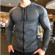 Front view of a grey men's hoodie, showcasing sleek compression design and breathable fabric for activewear.