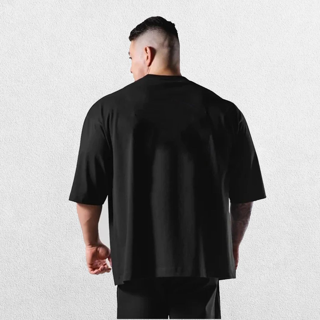 Casual styling of a BLack men’s gym shirt in studio background