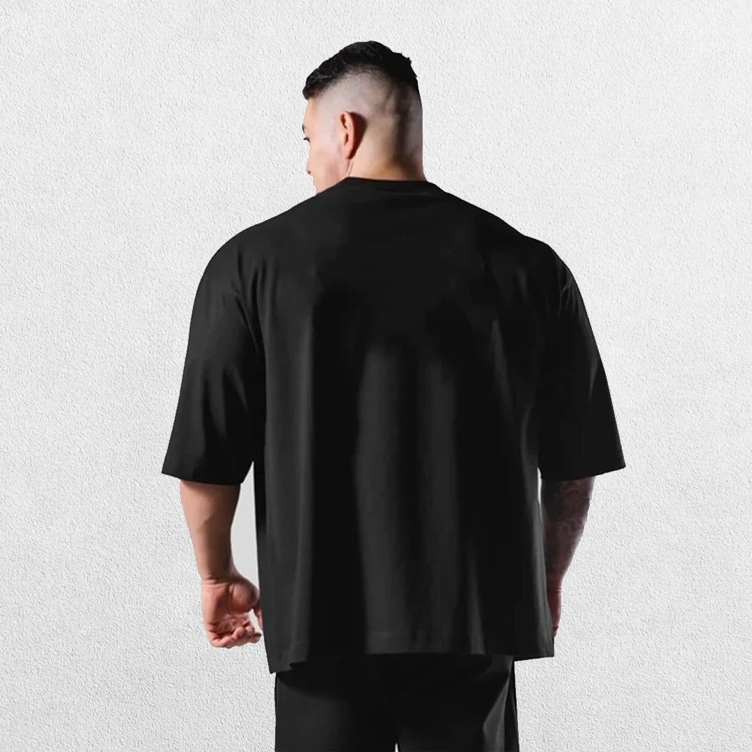 Casual styling of a BLack men’s gym shirt in studio background