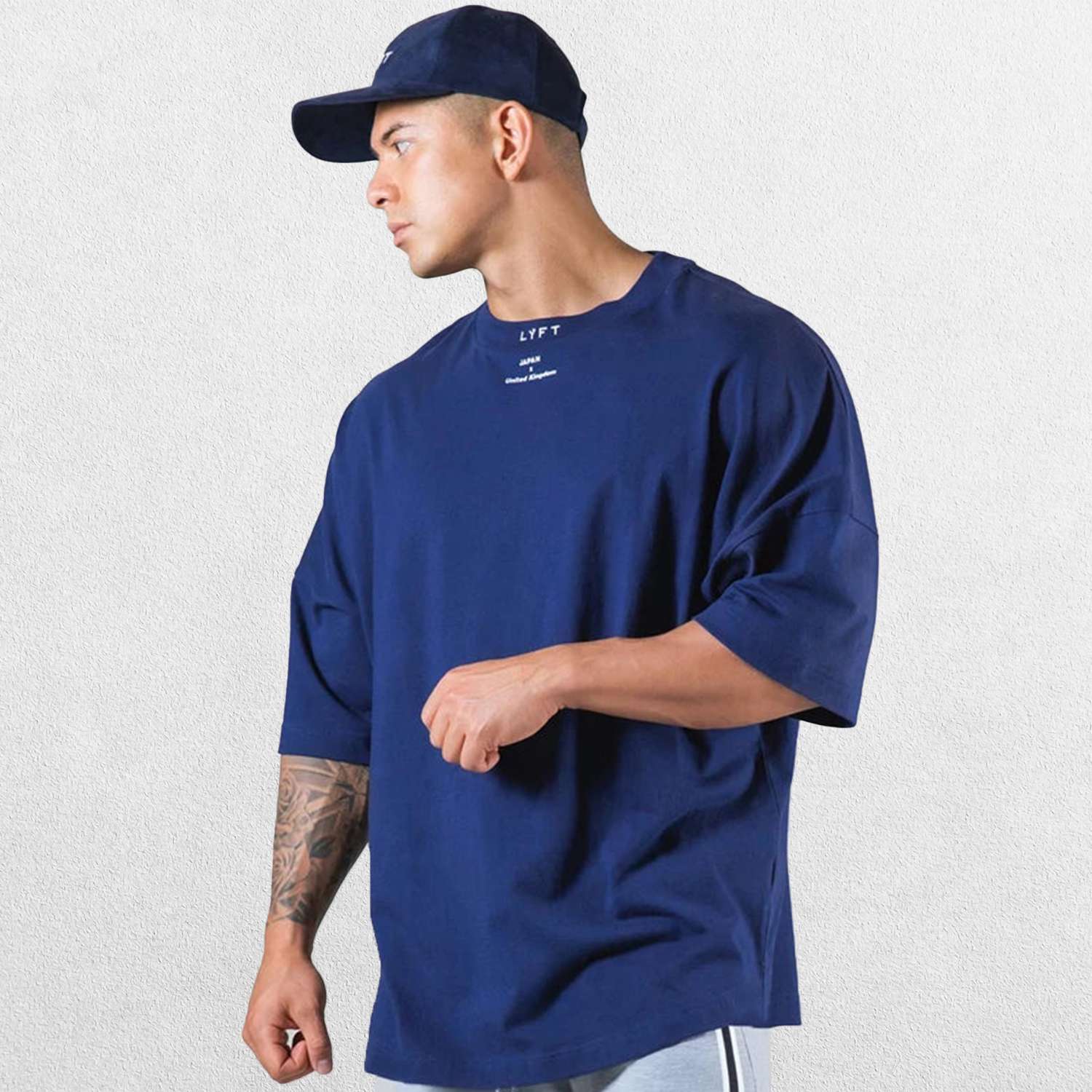 Casual styling of a Dark Blue men’s gym shirt in studio background