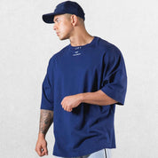 Casual styling of a Dark Blue men’s gym shirt in studio background