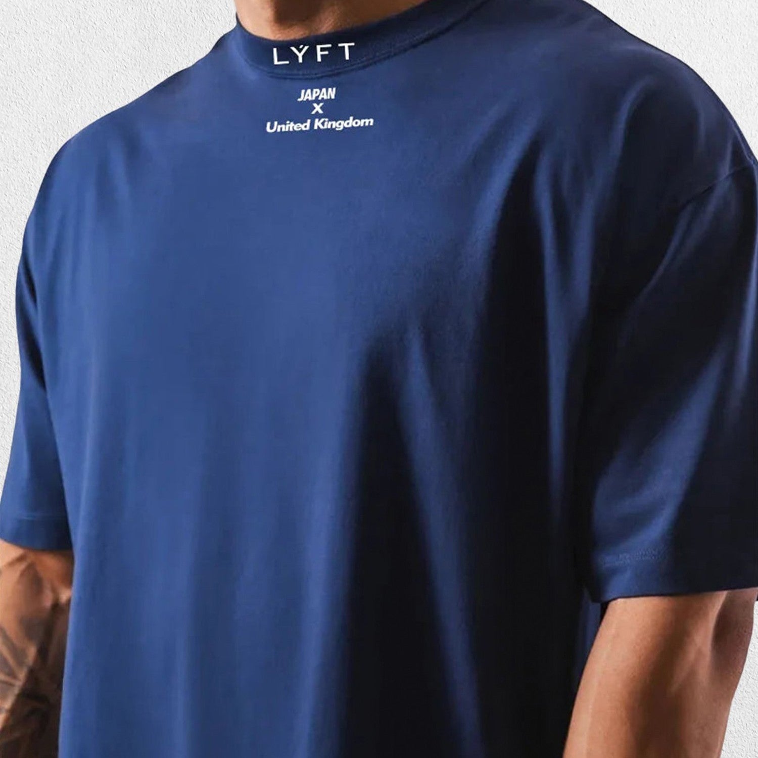 Casual styling of a Dark Blue men’s gym shirt in studio background