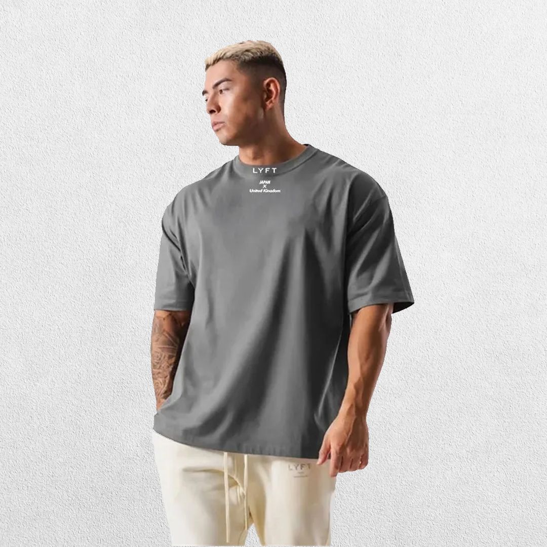 Casual styling of a Dark Grey men’s gym shirt in studio background