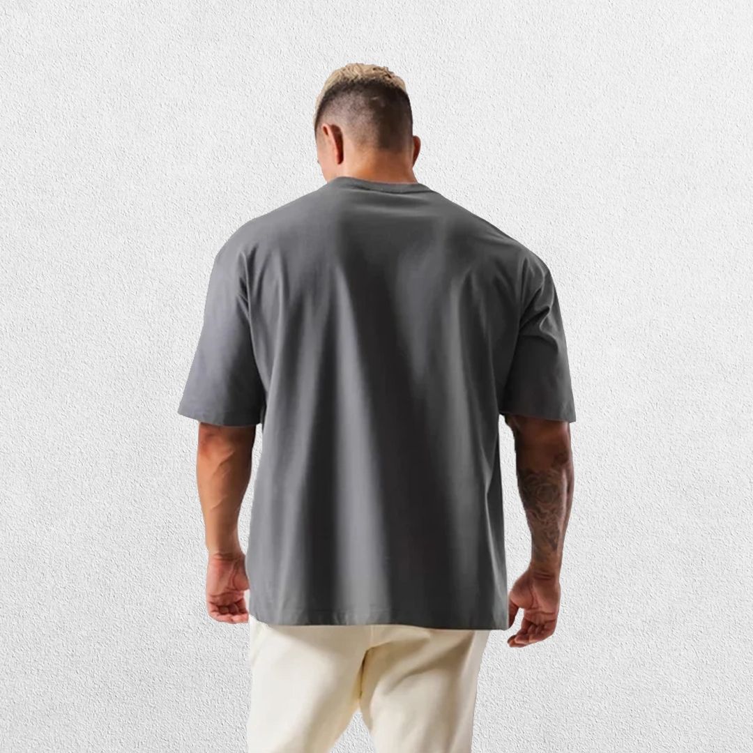 Casual styling of a Dark Grey men’s gym shirt in studio background