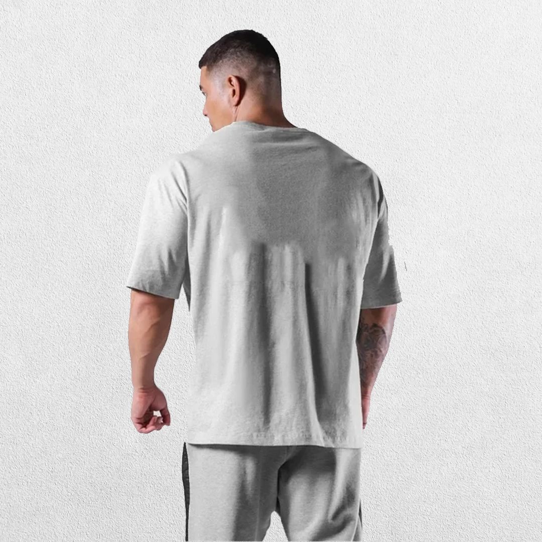 Casual styling of a Grey men’s gym shirt in studio background