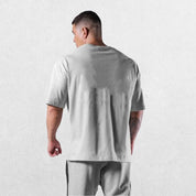 Casual styling of a Grey men’s gym shirt in studio background