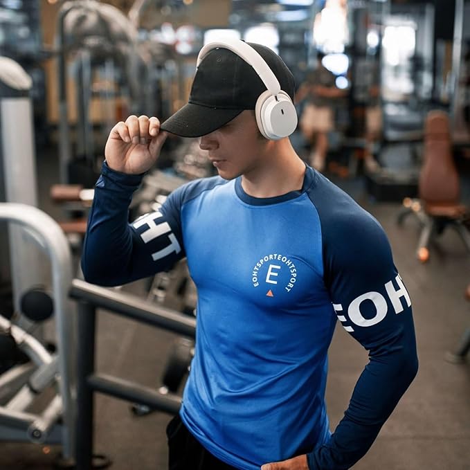 Model wearing GPW Men’s Bodybuilding Long Sleeve Shirt in blue, showcasing moisture-wicking fabric and slim fit in the gym.