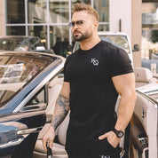 Model wearing Black GPW Men's Cotton Slim Fit T-Shirt showcasing athletic fit