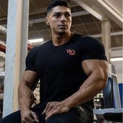 Model wearing black moisture-wicking GPW slim fit t-shirt during a workout