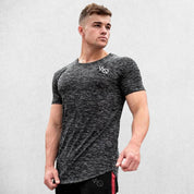 Model wearing Dark Grey GPW Men's Cotton Slim Fit T-Shirt showcasing athletic fit