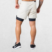 GPW Men's Double-Layered Gym Training Shorts in beige, back view featuring durable stitching and ergonomic fit.