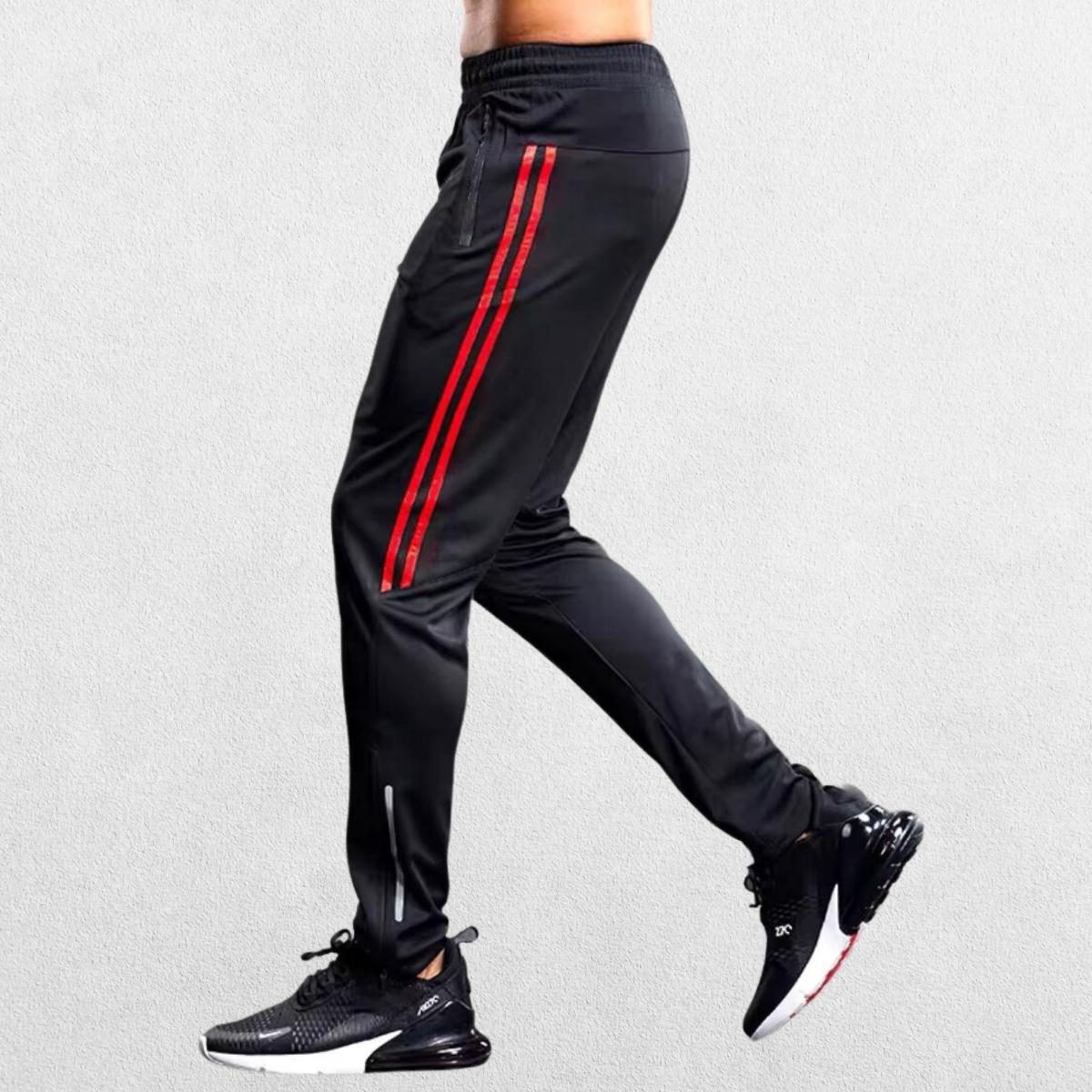 Red GPW gym joggers featuring sporty lines and zipper pockets.