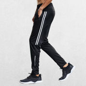 White GPW joggers with slim fit and sporty side accents.