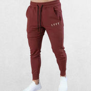 Rose red GPW lightweight breathable pants with logo for men’s activewear.
