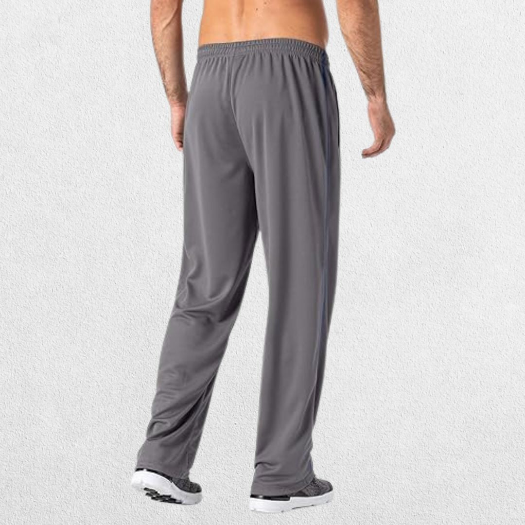 GPW Men’s Lightweight Loose Fit Open Bottom Mesh Athletic Trousers Dark Grey Back View in Studio Background.