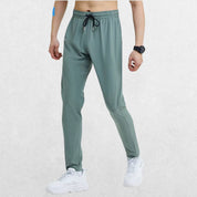 GPW Men's Slim Fit Pencil Pants in grey blue, front view highlighting the unique color and athletic fit against a clean studio setting.