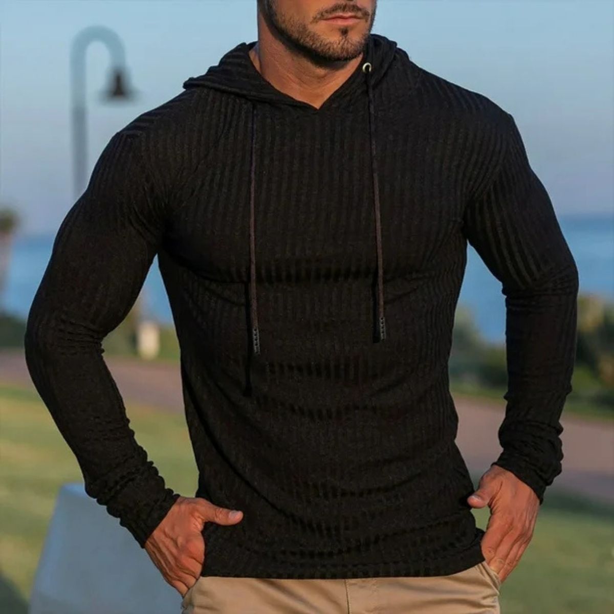 Lifestyle image of a model confidently wearing black Men’s Slim Fit Sport Hoodie, embodying active style.