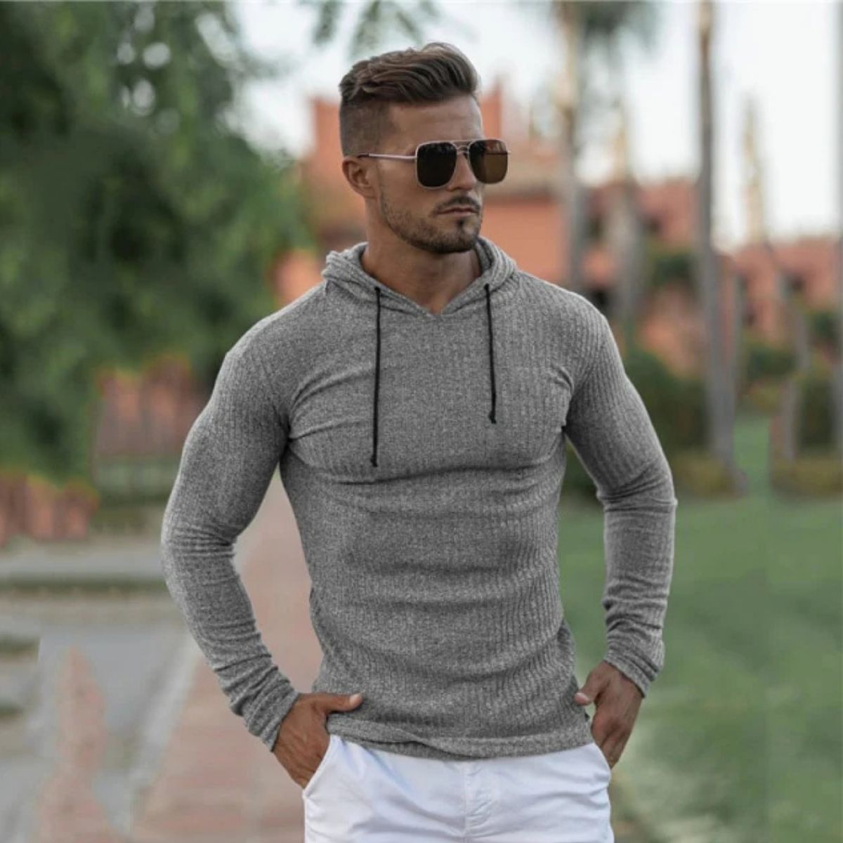 Cool lifestyle shot of a model outdoors wearing the grey Men’s Slim Fit Sport Hoodie, styled effortlessly