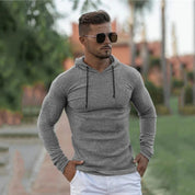 Cool lifestyle shot of a model outdoors wearing the grey Men’s Slim Fit Sport Hoodie, styled effortlessly