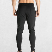 GPW Men’s Slim Fit Zip Athletic Pants Black Back View in Studio Background