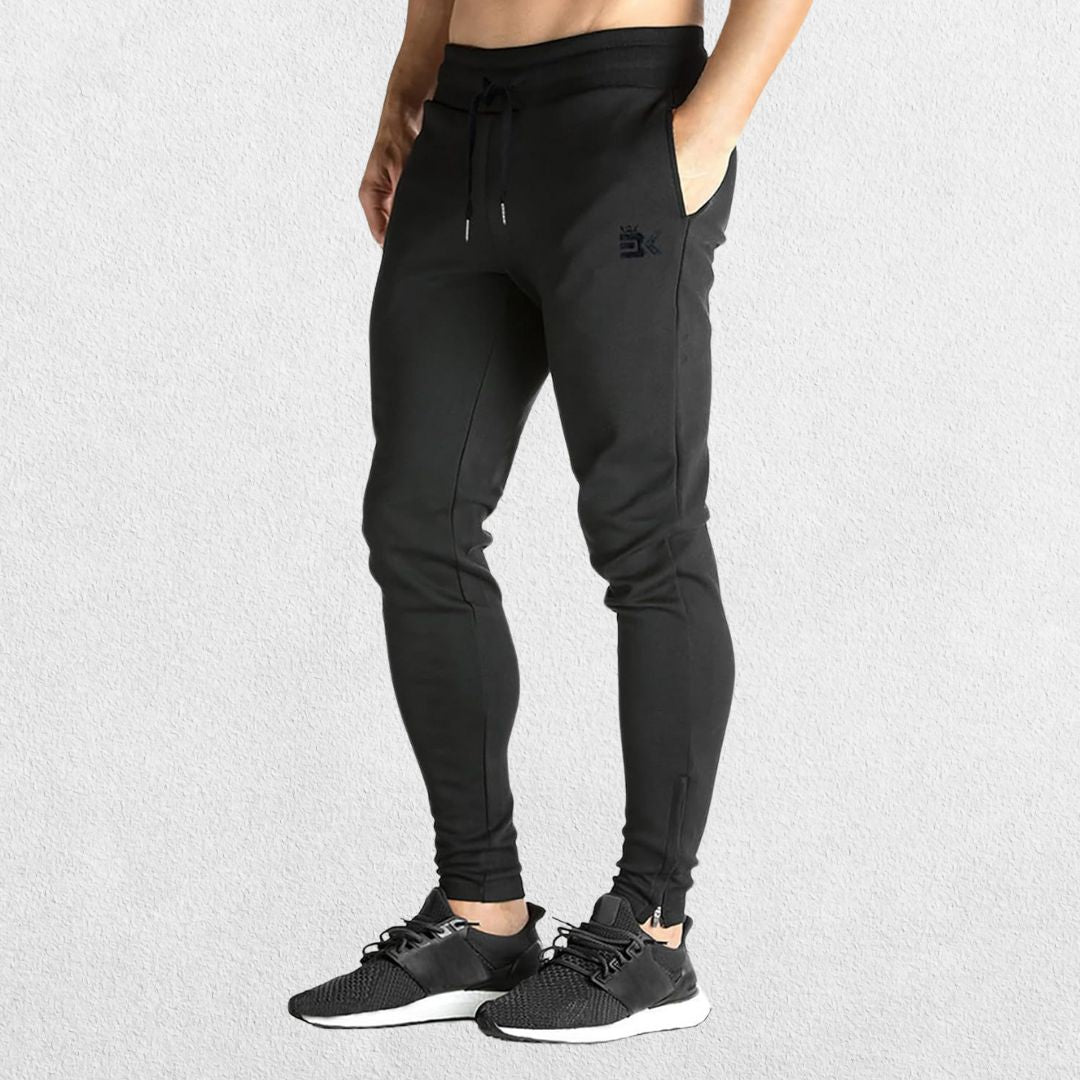 GPW Men’s Slim Fit Zip Athletic Pants Black Side View in Studio Background