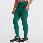 GPW Men’s Slim Fit Zip Athletic Pants Dark Green Front View in Studio Backgroun