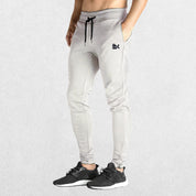 GPW Men’s Slim Fit Zip Athletic Pants Heather Grey Front View in Studio Background.