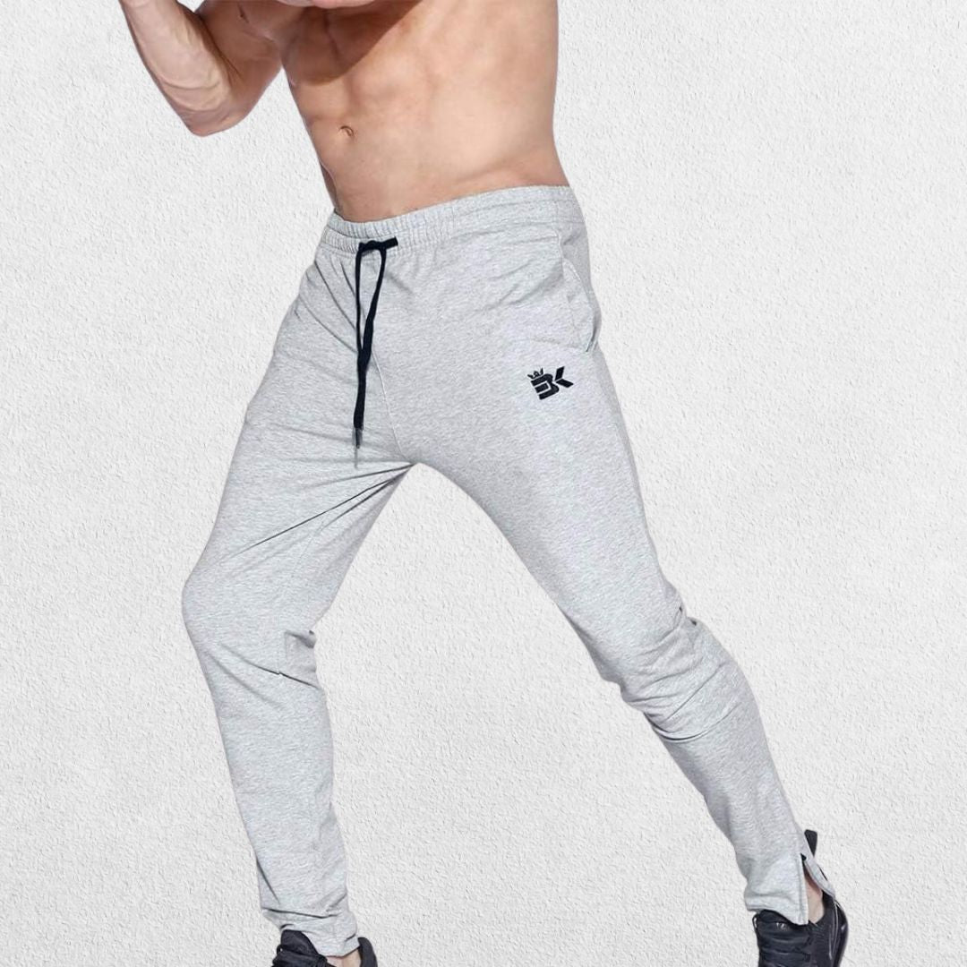 GPW Men’s Slim Fit Zip Athletic Pants Heather Grey Side View in Studio Background.