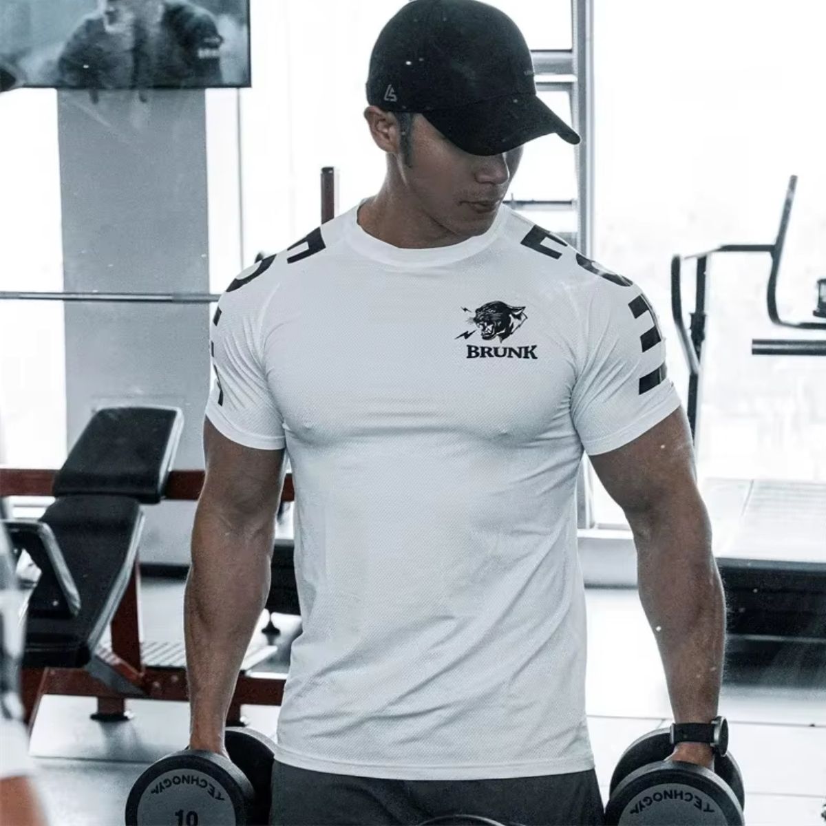 Model in gym wearing white GPW Men's Quick-Dry T-Shirt, showcasing comfort and quick-dry features