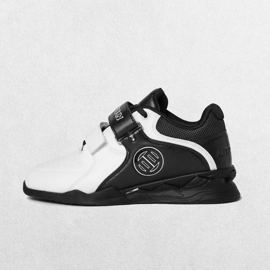 Side view of Black raised heel promoting proper form during a squat.