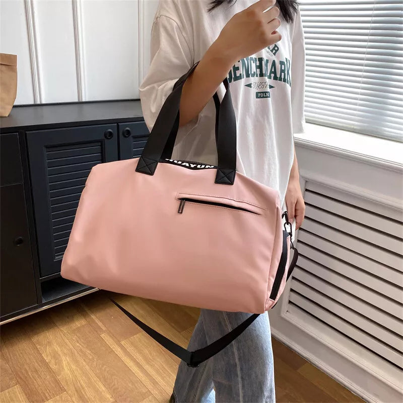 Lifestyle shot of the Pink GPW bag atop a travel trolley, emphasizing its versatility and style.