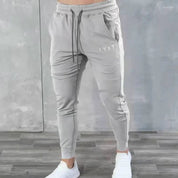 Lifestyle image of GPW men’s grey slim-fit joggers look.