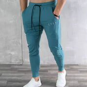 Model wearing GPW men’s blue breathable joggers with hand in pocket for a relaxed, athletic vibe.