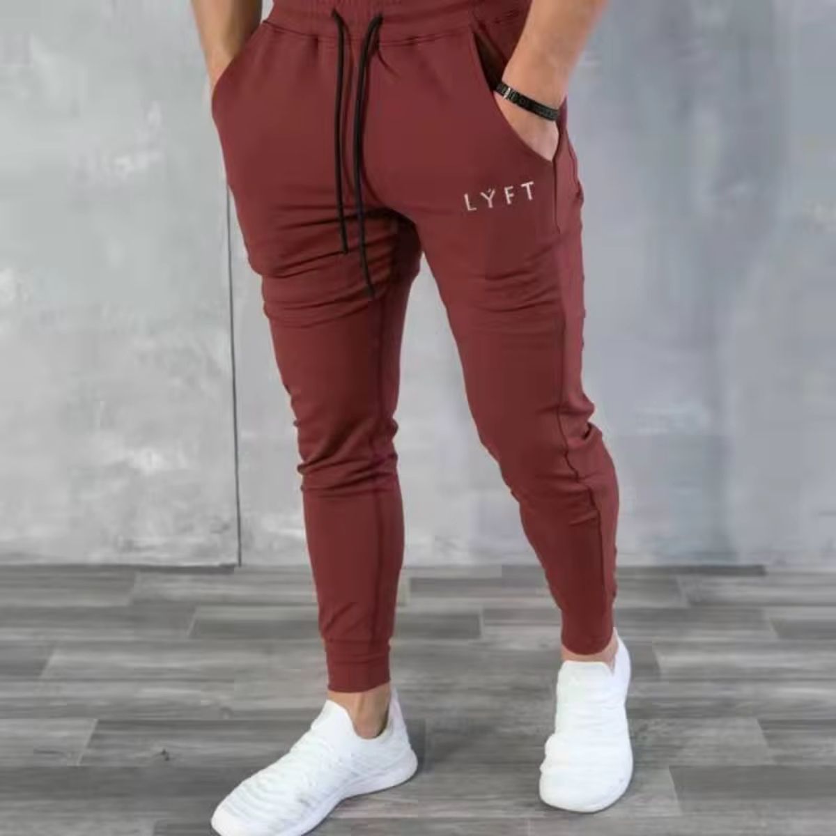 Lifestyle image of GPW men’s rose red joggers, blending vibrant color with sporty comfort.