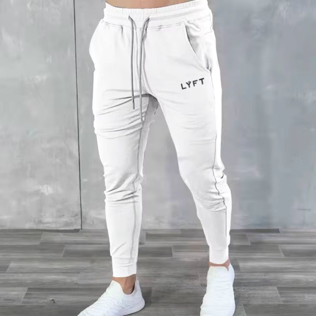 Model in GPW men’s white breathable joggers for an athletic style