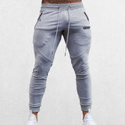 Close up of Model Wearing Grey Breathable Men’s Training Joggers with Adjustable Drawstring and Secure Pockets