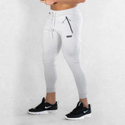 Side View Of Model Wearing Grey Breathable Men’s Training Joggers with Adjustable Drawstring