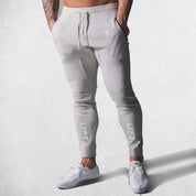 Model Wearing Light Grey Men’s Fitness Workout Cotton Skinny Joggers for Running, Fitness & Bodybuilding
