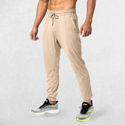 Light Khaki GPW Men's Athletic Sweatpants featuring zipper pockets, athletic fit, and sleek design.