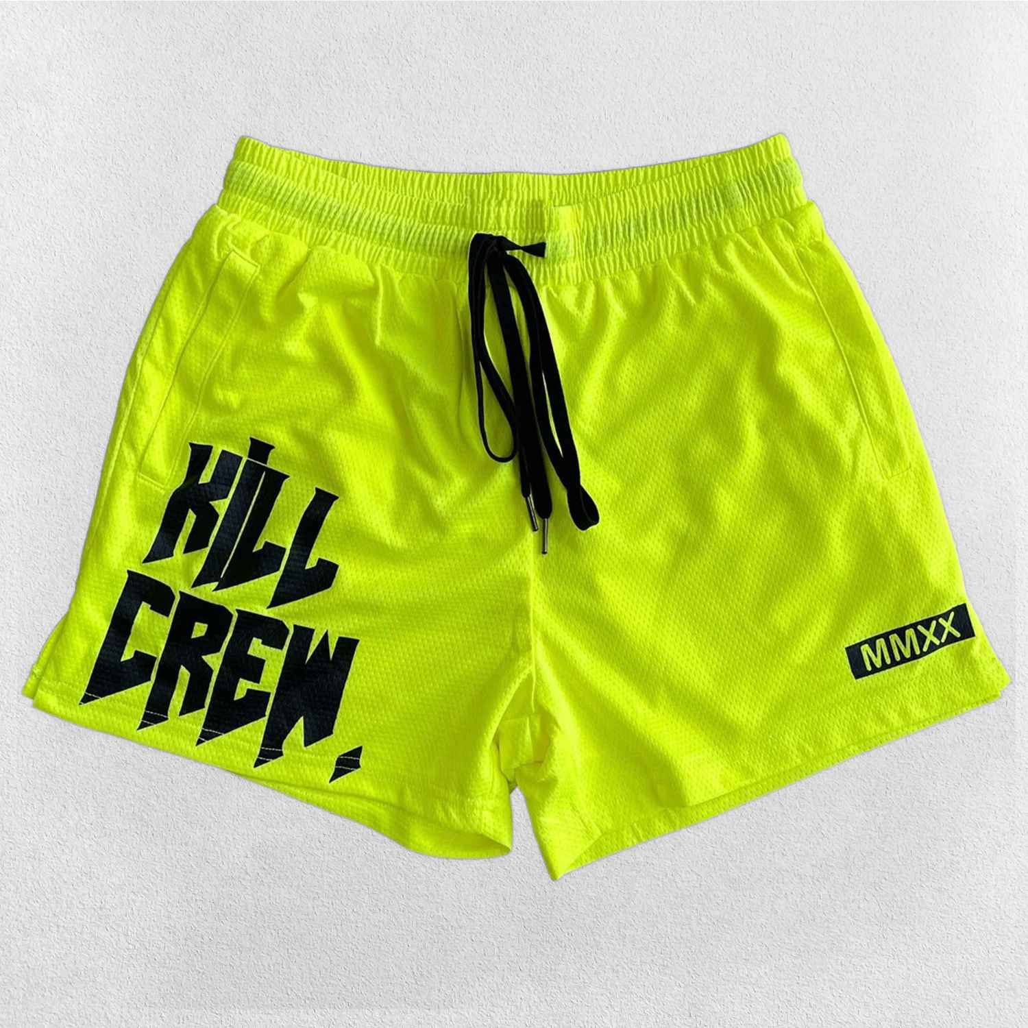 Close-up of Lime bold Kill Crew graphic print on GPW gym shorts.