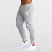 Man Pants Summer Casual Trousers in dim grey, offering a sleek, modern look with moisture-wicking fabric for comfort during training.