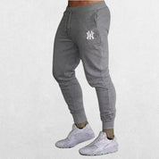 Slim-fit Man Pants Summer Casual Trousers in grey, showcasing a breathable and flexible design perfect for fitness and casual wear.
