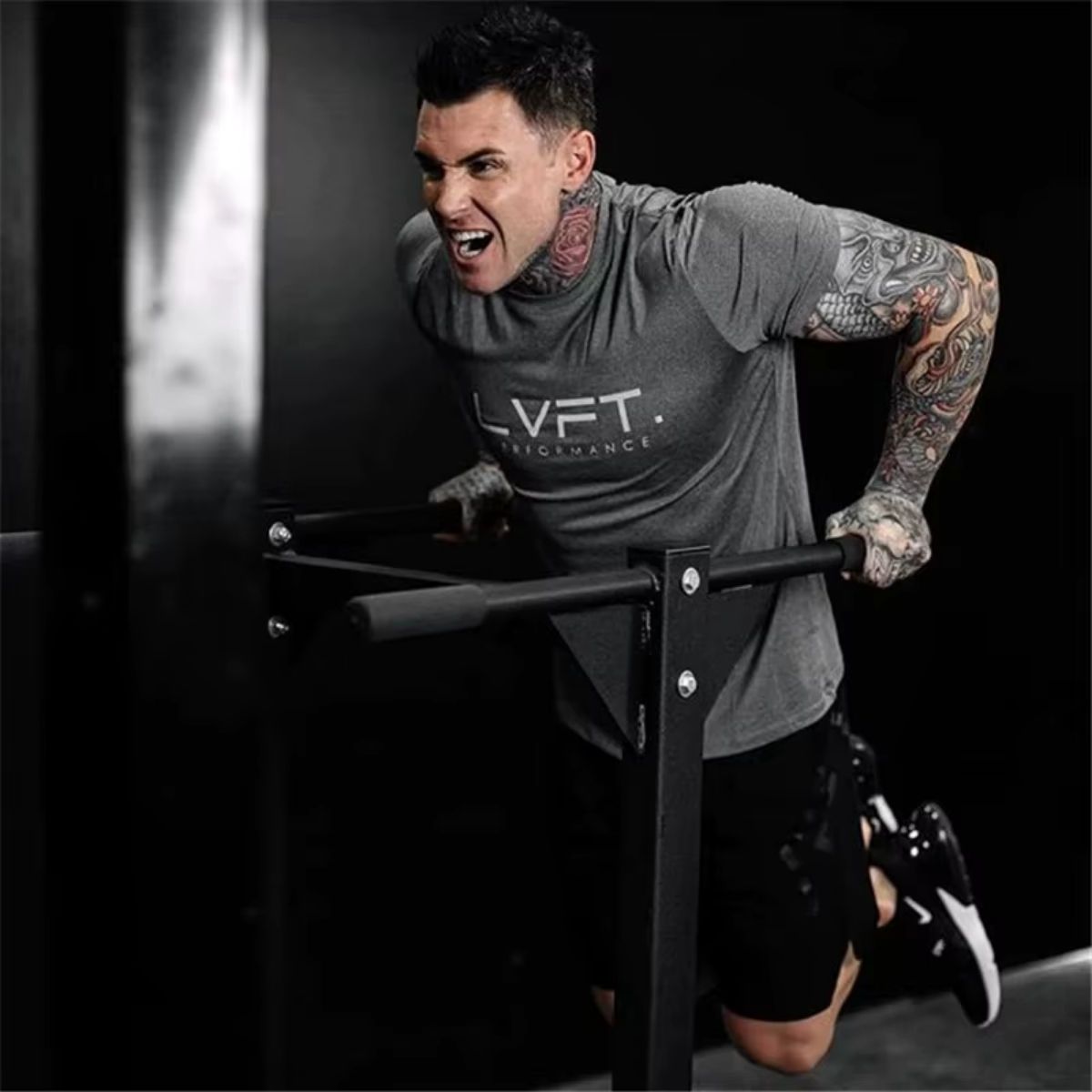 Model wearing Summer T-shirt Jogger Quick Dry Sports Shirt in grey, demonstrating flexibility and comfort in the gym