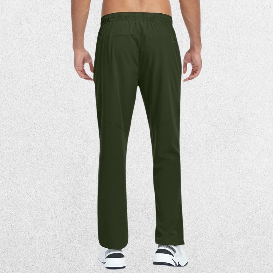 Back view of Men's Lightweight Quick-Dry Hiking Trousers in green, showcasing functional design and fit in a studio setting