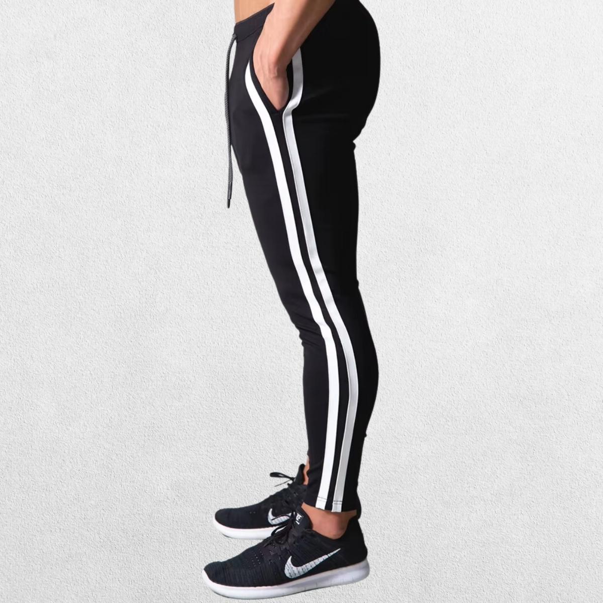 Side profile of Men’s Striped Joggers in black, highlighting the sporty striped design and tapered leg.