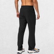 Men’s Workout Athletic Trousers with Elastic Waist and Zipper Pockets, black, shown from the back side of the model, highlighting the fit and design.
