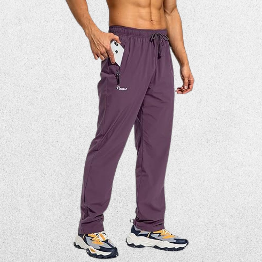 Men’s workout athletic trousers in eggplant color with elastic waistband and zipper pockets, offering comfort and secure storage