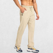 Khaki men's workout trousers with secure zipper pockets and adjustable elastic waistband, perfect for training